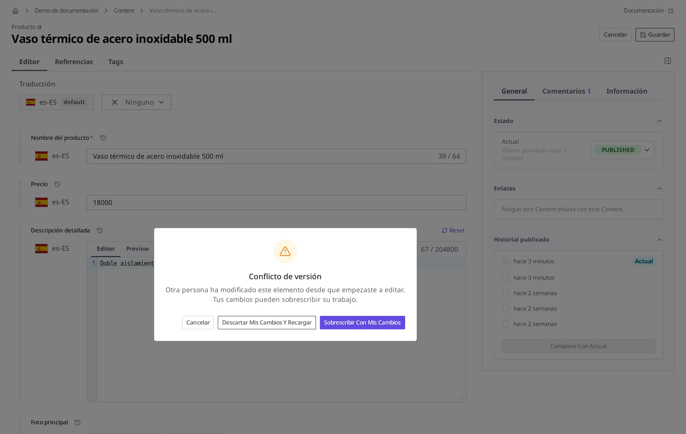 Ventana de aviso de conflicto de versión que aparece al guardar. Junto con el texto «Otra persona ha modificado este elemento desde que empezaste a editar. Tus cambios pueden sobrescribir su trabajo.», muestra tres botones: Cancelar, Descartar mis cambios y recargar y Sobrescribir con mis cambios