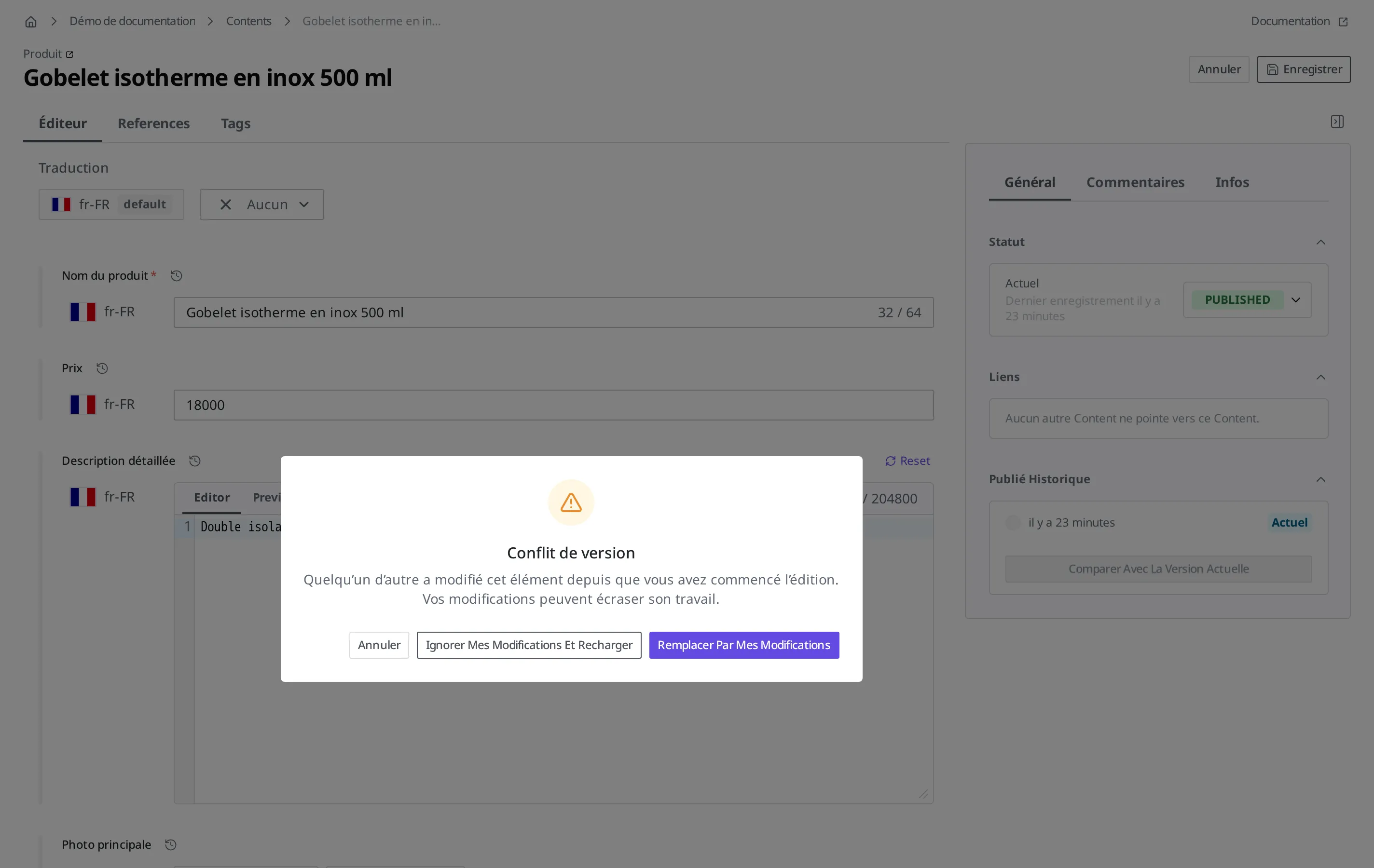 Fenêtre d'avertissement de conflit de version qui apparaît lors de l'enregistrement. Elle affiche le message « Quelqu'un d'autre a modifié cet élément depuis que vous avez commencé l'édition » ainsi que trois boutons : Annuler, Ignorer Mes Modifications Et Recharger, Remplacer Par Mes Modifications